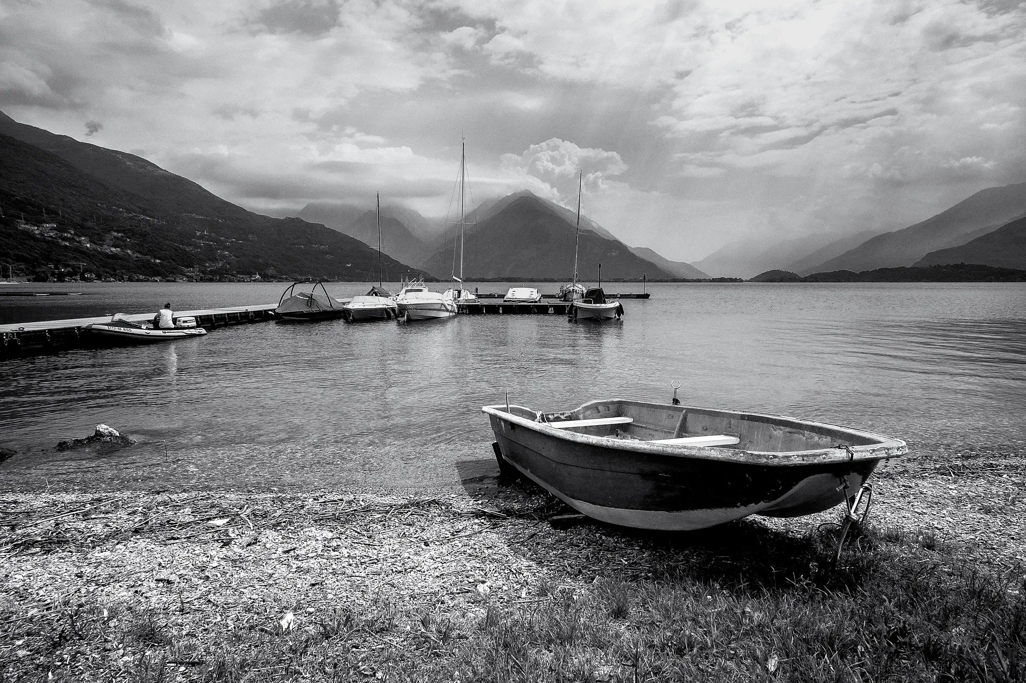 Black and white landscape of the lake dock with some boats