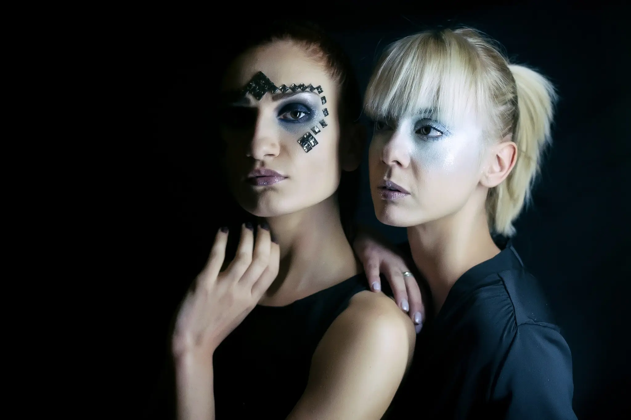 Portrait of two models in a futuristic makeup