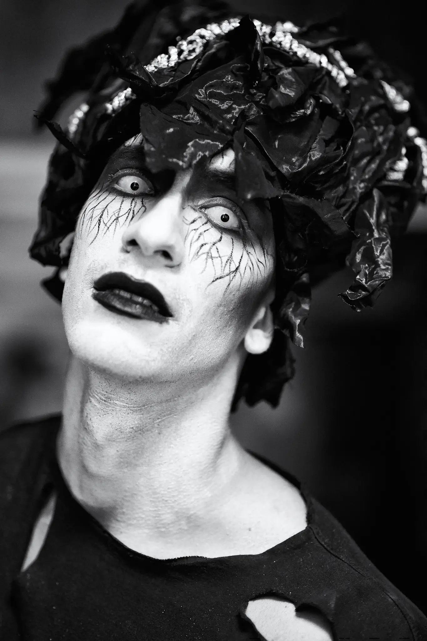 Black and white portrait of male model with makeup and outfit of a Halloween set