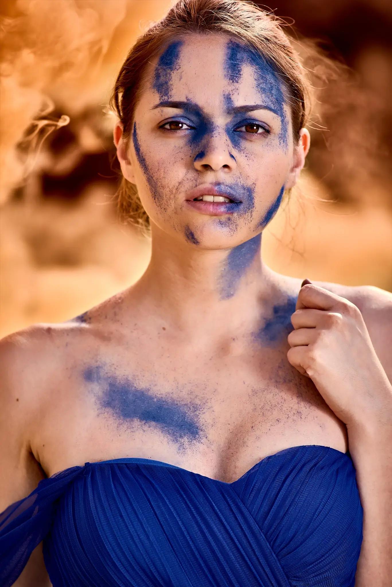 Unpublished - Portrait of model in blue dress with orange smoke