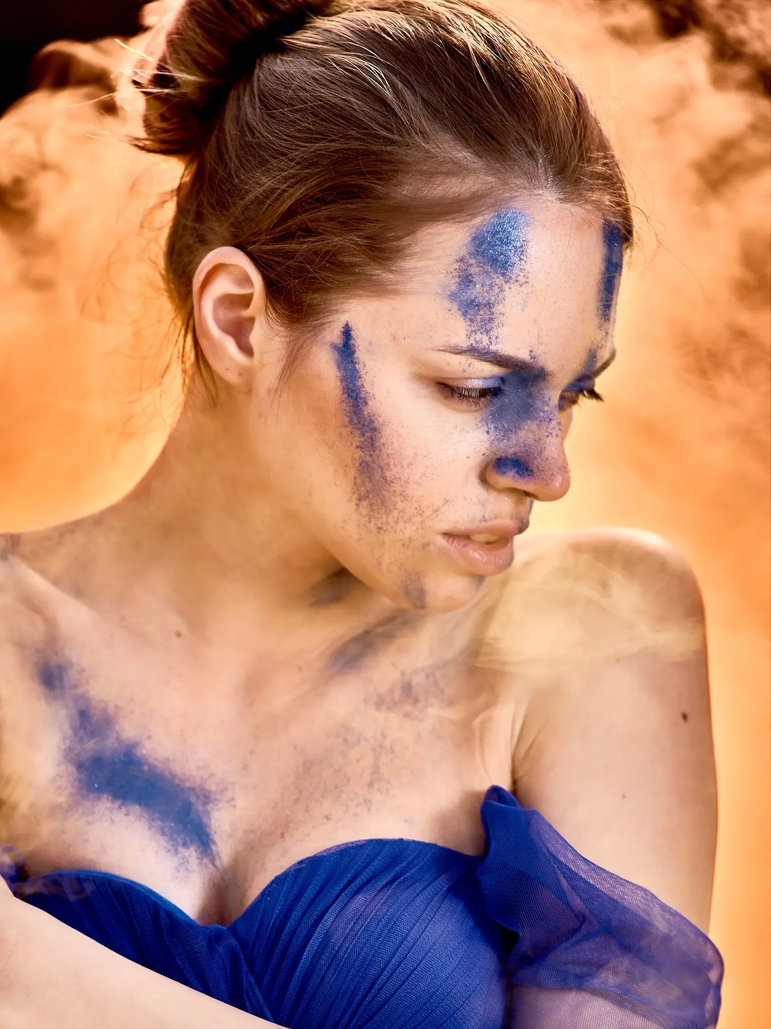 Unpublished - Portrait of model in blue dress with orange smoke