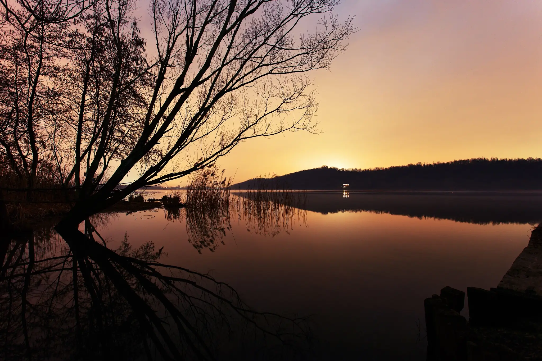 Night photography on the lake with eerie lights from thew city