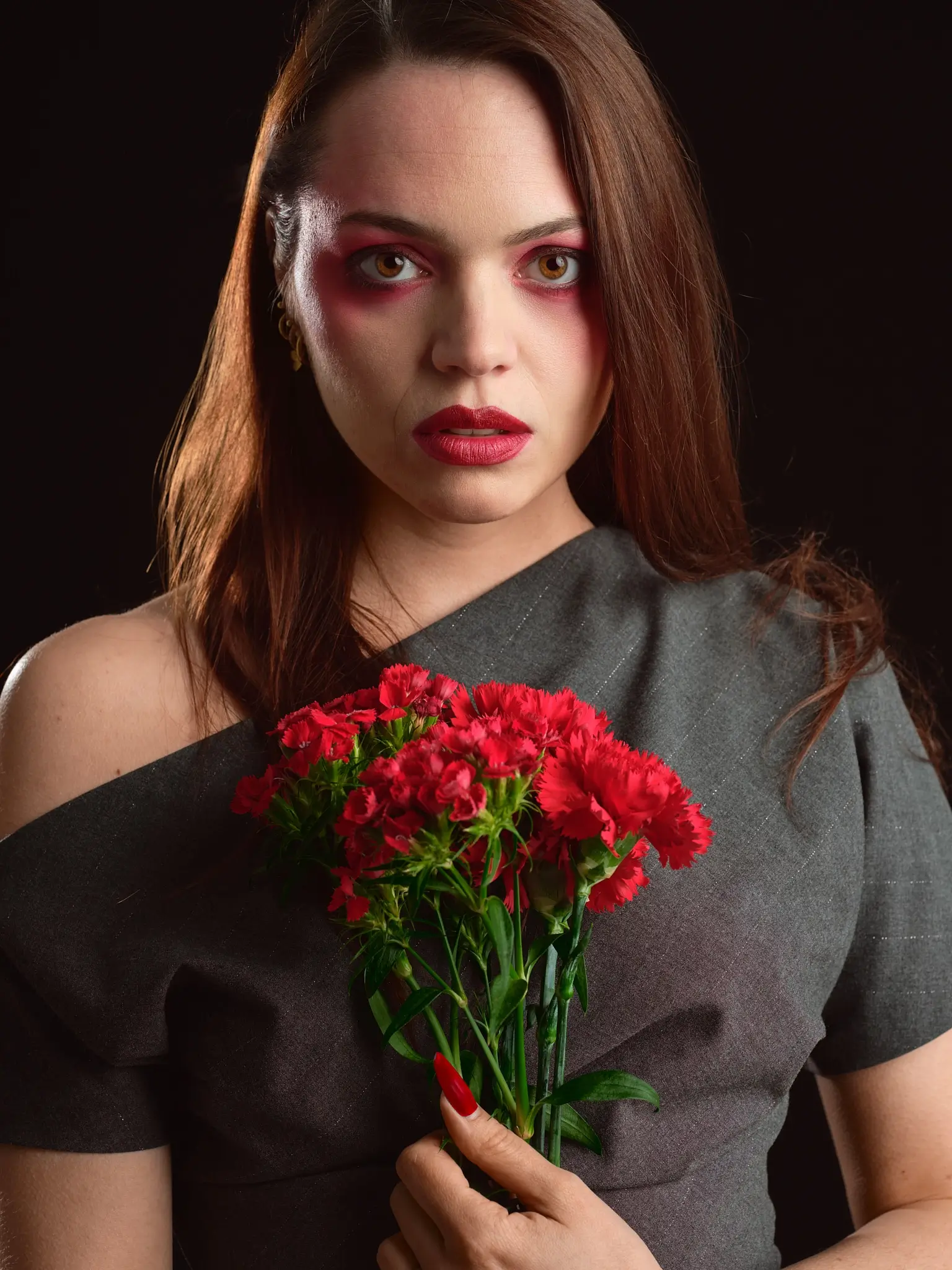 Portrait of a long‑haired brunette woman in soft studio light on black background, with flower‑matching makeup. Part of “The Flower Project” by Matteo Franchi.