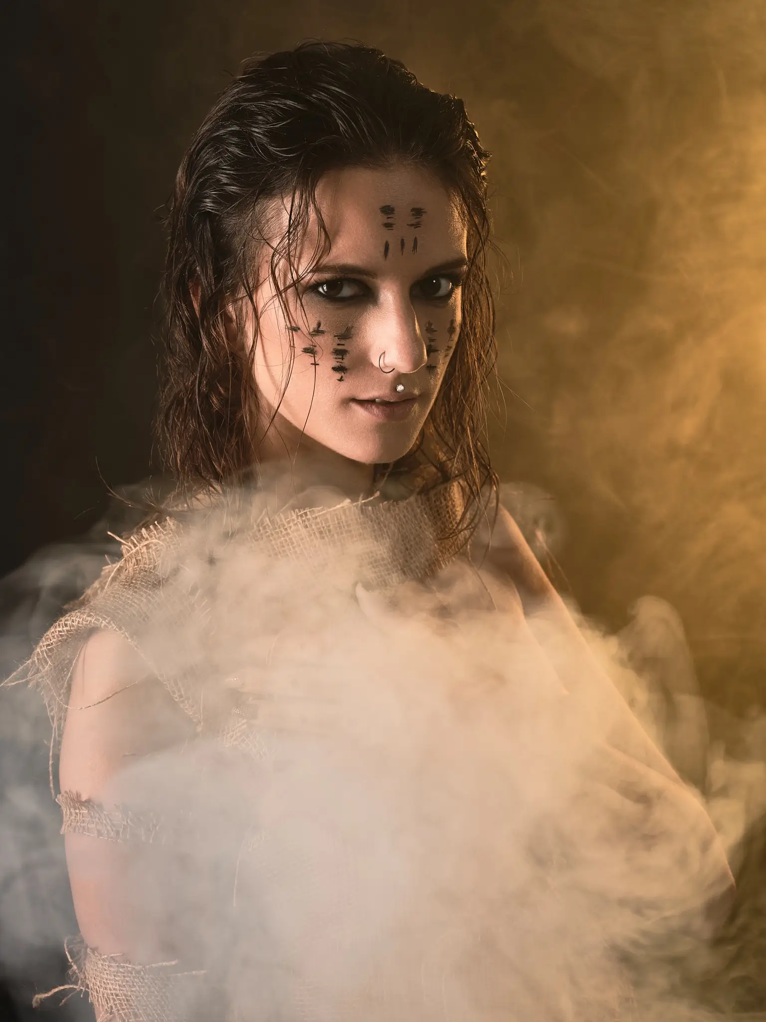 Artistic photoshoot with smoke and lights, dramatic mood