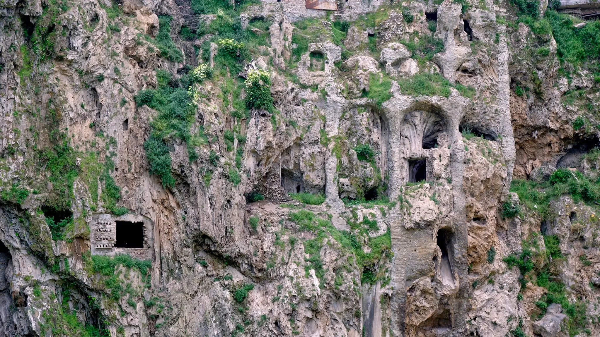 Historic ruins embraced by wild vegetation in Villa Gregoriana