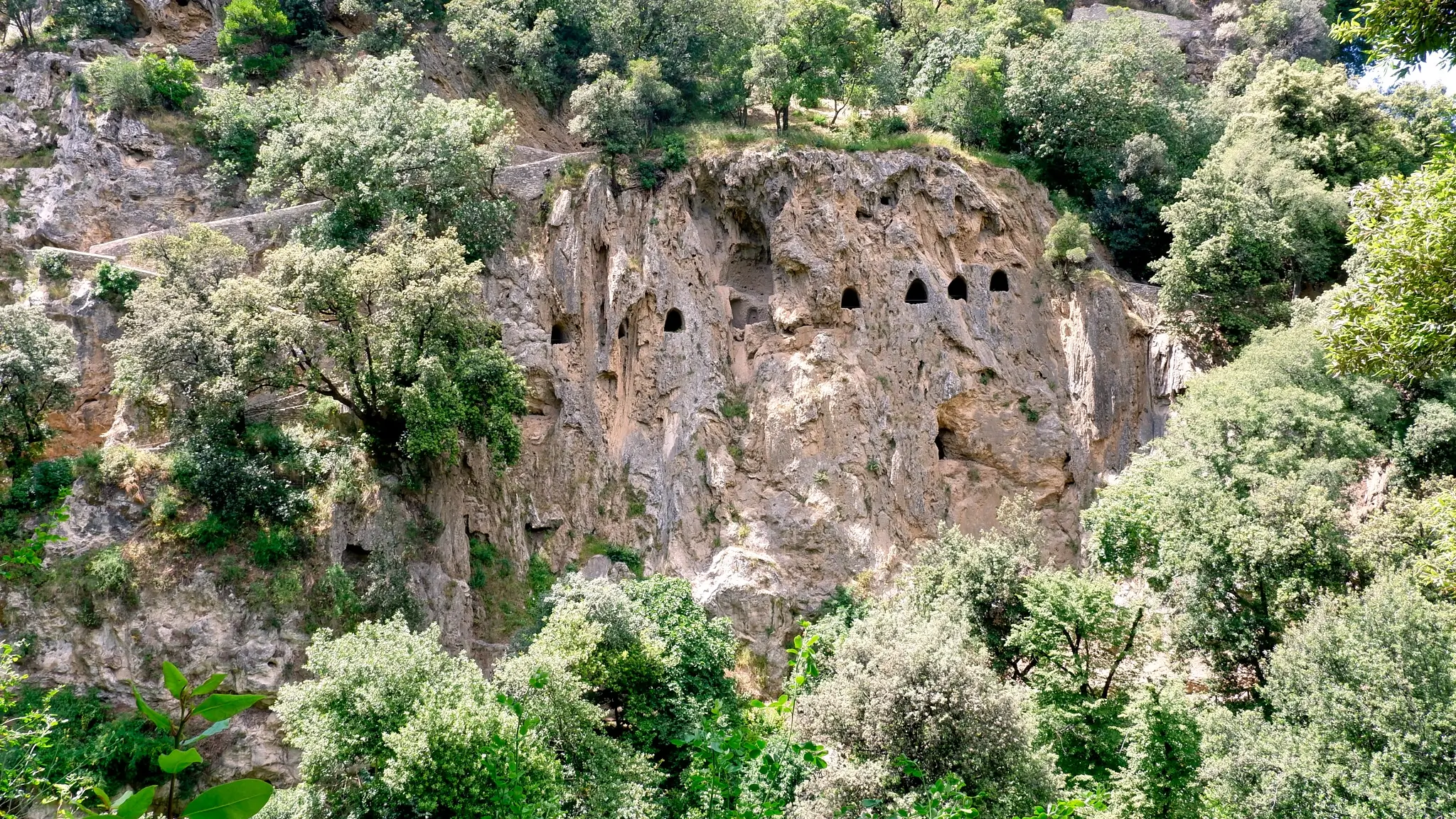 Historic ruins embraced by wild vegetation in Villa Gregoriana