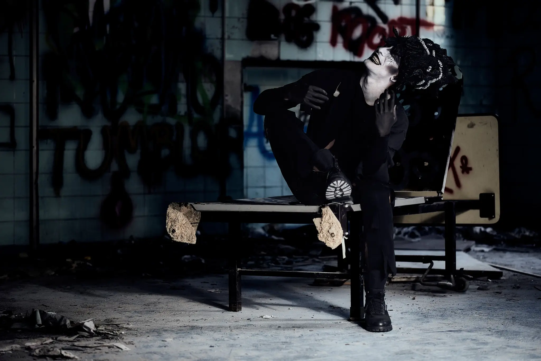 Wide shot of the abandoned asylum rooms, setting the unsettling atmosphere of this Halloween-inspired photo series.