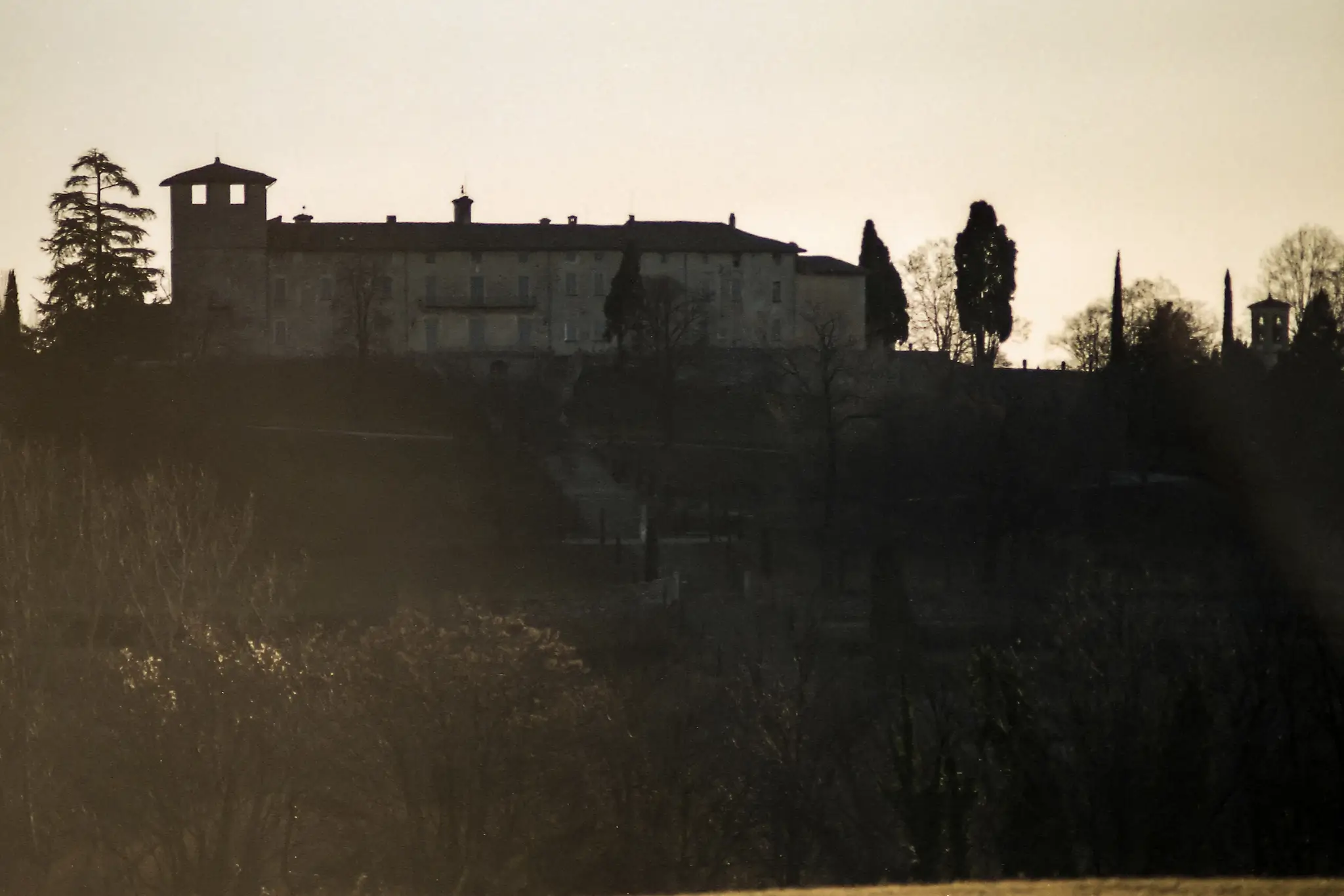 Silhouetted villa on a hill captured on 35mm film, recalling Christmas memories