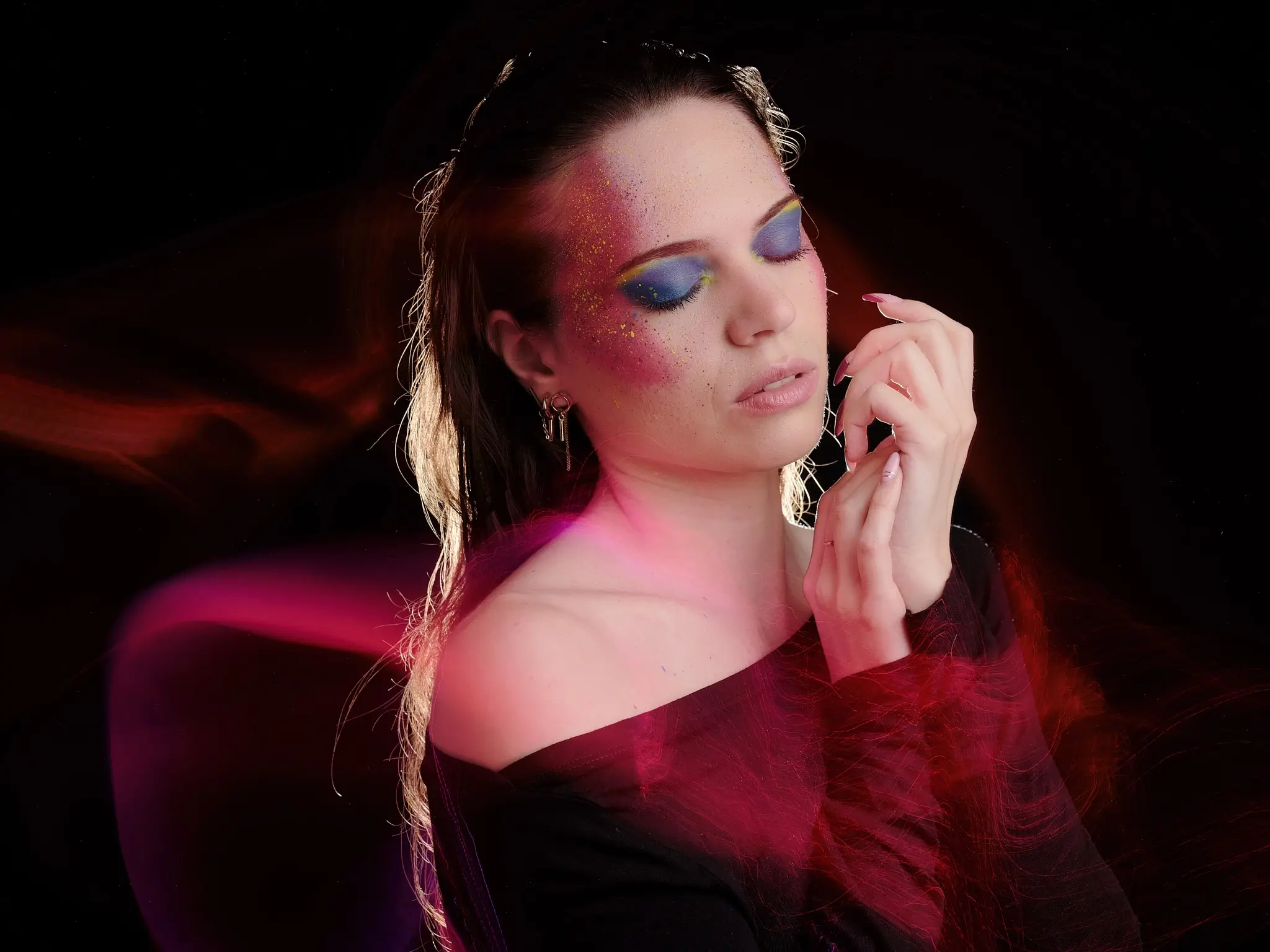 Close-up portrait with creative makeup and colorful light painting effects using optical fibers