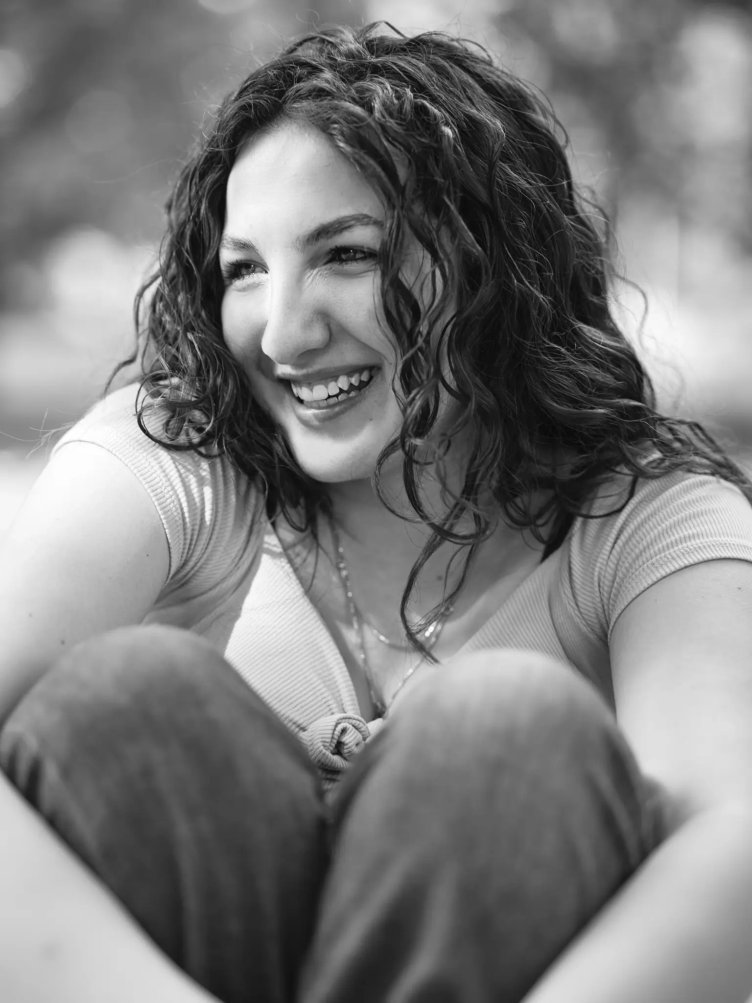Desiré portrayed while smiling in a black and white image. Location of the set was the city park